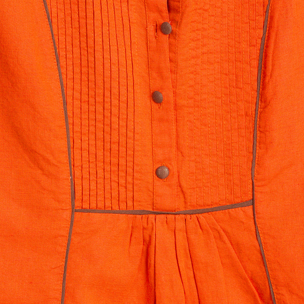 In-Sattva Women's Orange Tunic Top featuring contrast piping and cap sleeves, design detail close-up