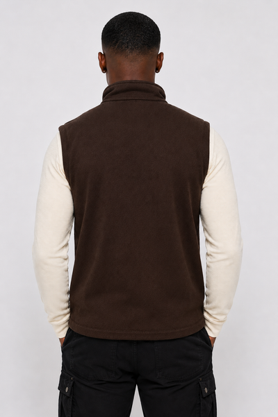 Angled front view of men's brown softshell zip-up vest, highlighting weather-resistant layering built to last.