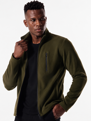 Lifestyle front view of Macho Genie men's olive green softshell jacket, highlighting weather-resistant outdoor wear.