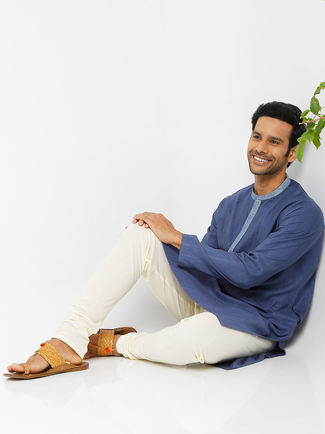 Men's blue embroidered cotton knee-length kurta, fabric texture detail.