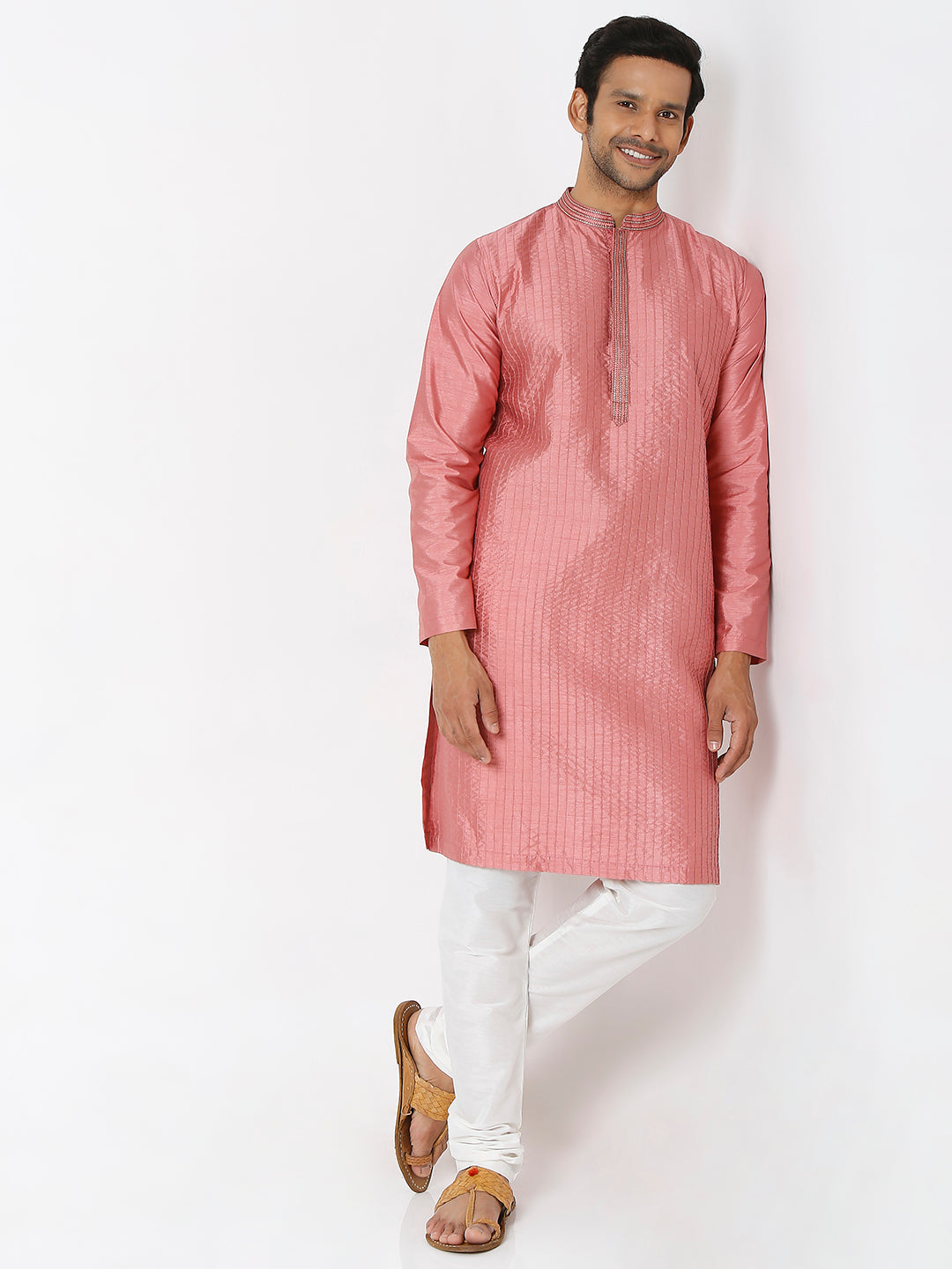 Men's pink embroidered cotton knee-length kurta, fabric texture detail.