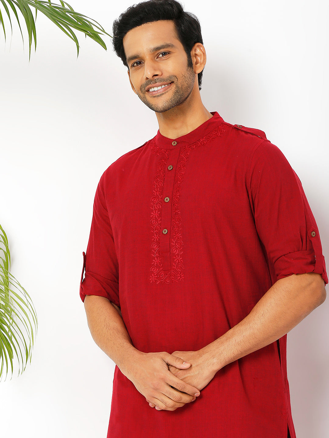 Men's red cotton mandarin collar knee-length kurta, fabric texture detail.