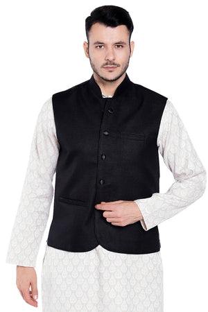 Front view of Shatranj men's black three-pocket Nehru vest, highlighting functional, classic wedding guest style.