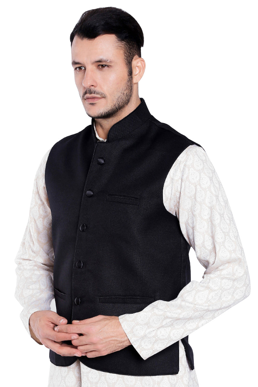 Left-side view of men's black three-pocket Nehru vest, highlighting functional, classic wedding guest style.