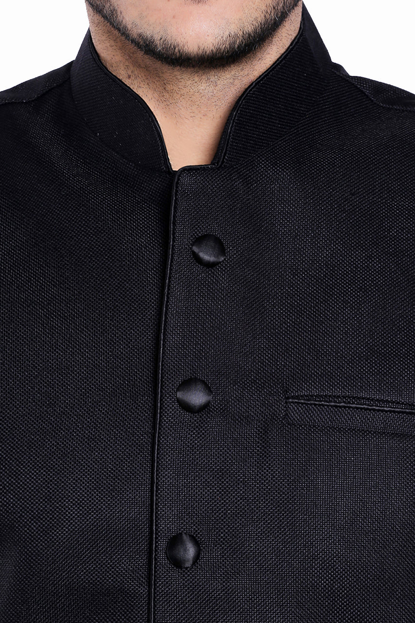 Three-pocket design close-up of men's black three-pocket Nehru vest, highlighting functional, classic wedding guest style.