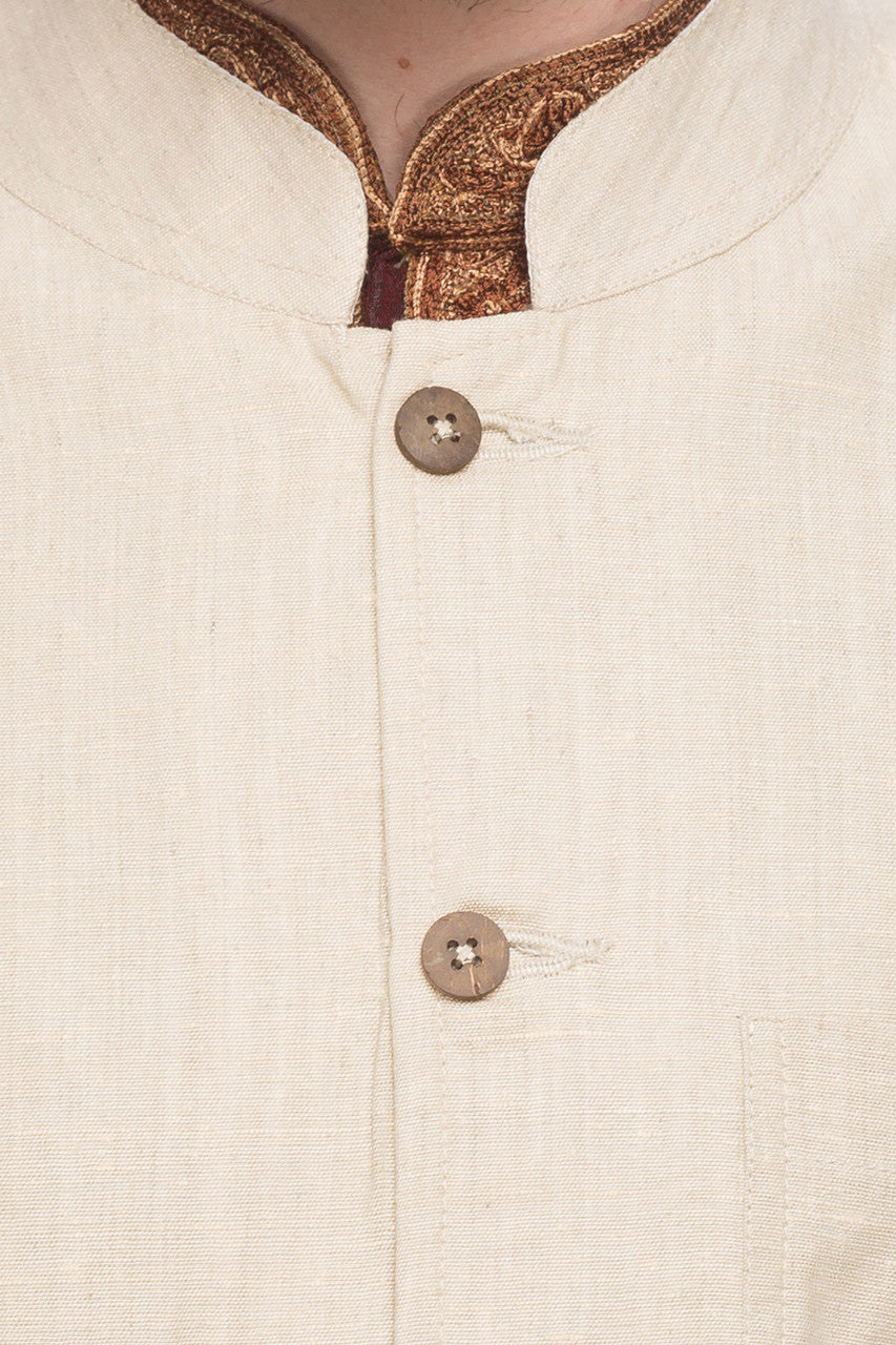 Collar and button close-up of men's natural-tone Mandarin collar vest, highlighting wedding guest style with ethnic details.